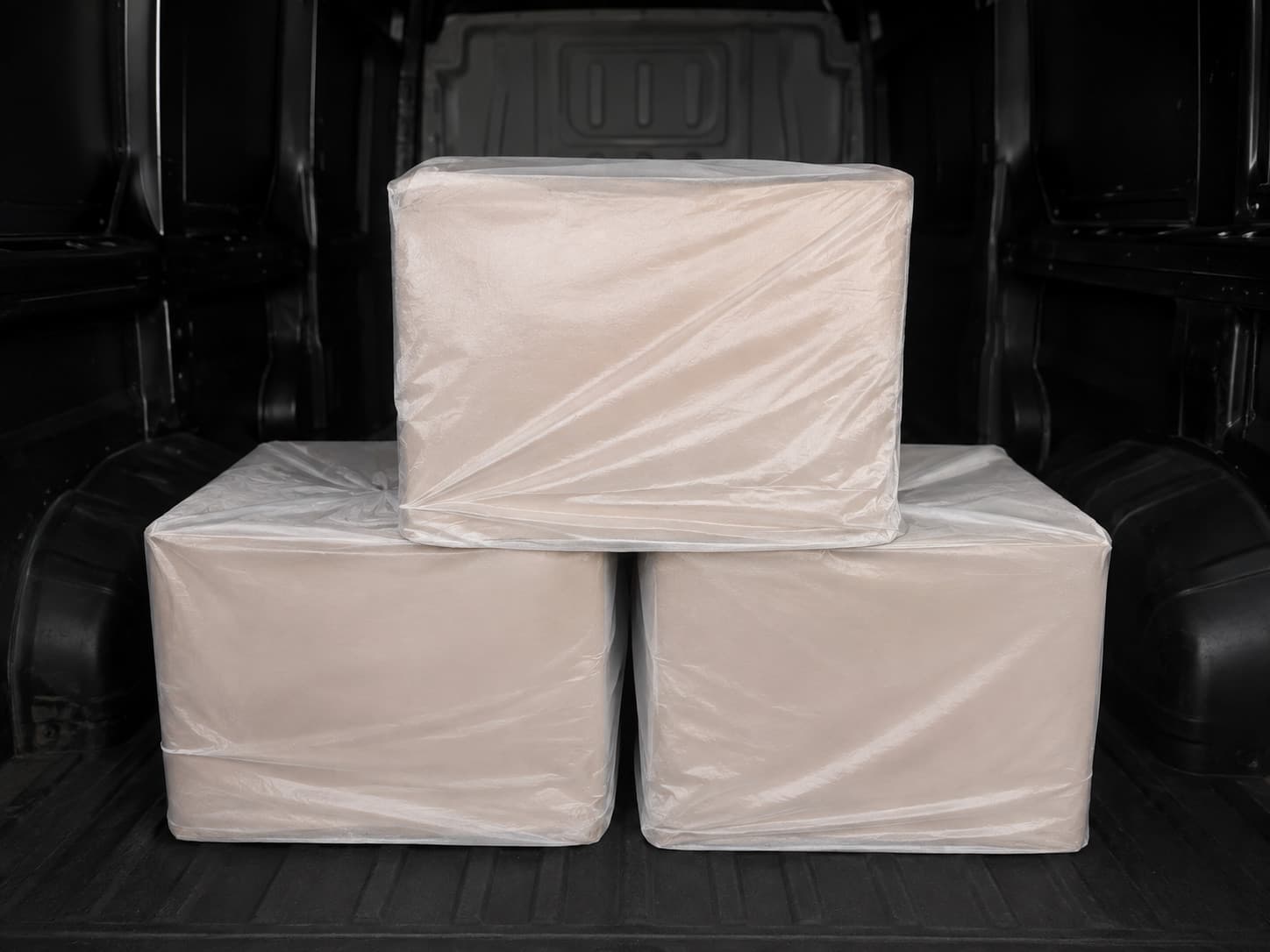 Boxes of fruit wrapped and stacked in the back of the delivery van